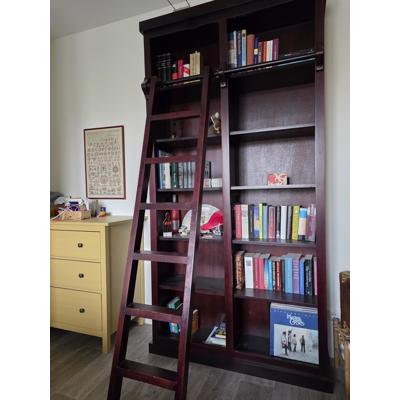 Donkerrode houten bibliotheekkast met trap