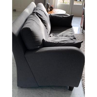 Grijs stoffen twee-zits bankje.