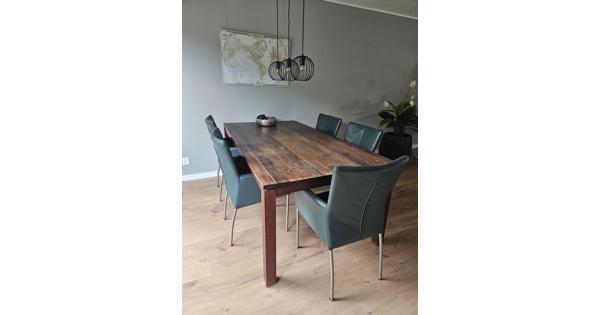 massief houten tafel met 5 leren stoelen