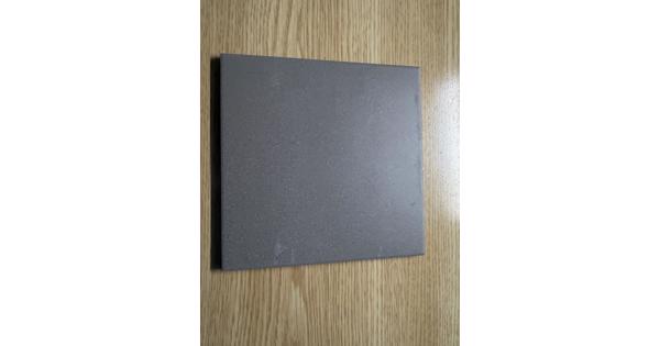 15 doosjes grijze 15 x 15 vloertegels